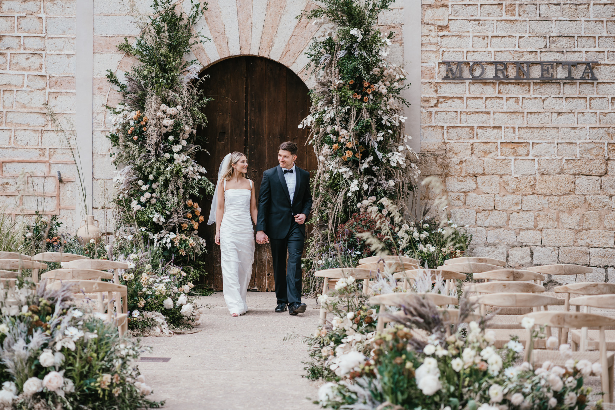 Finca Morneta Wedding Mallorca (c)Liz Greenhalgh Photography Flower Pillars Arch Door Greenery Cream Toffee Wild Natural Ceremony