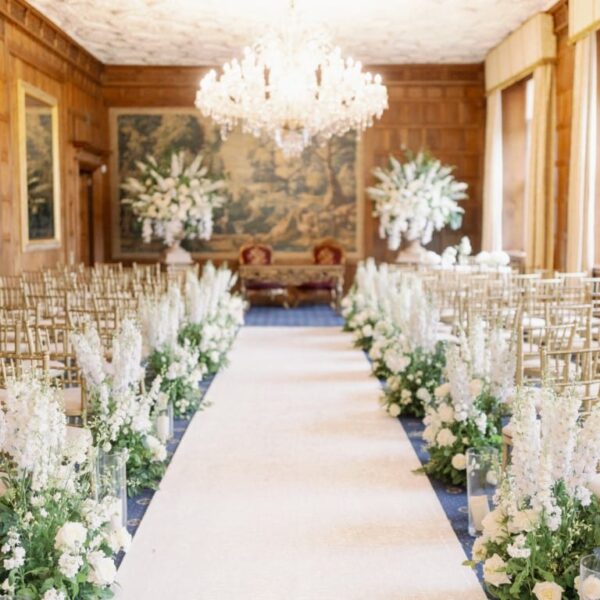 White garden aisle runners and impressive urn designs in the long gallery at North Mymms Park