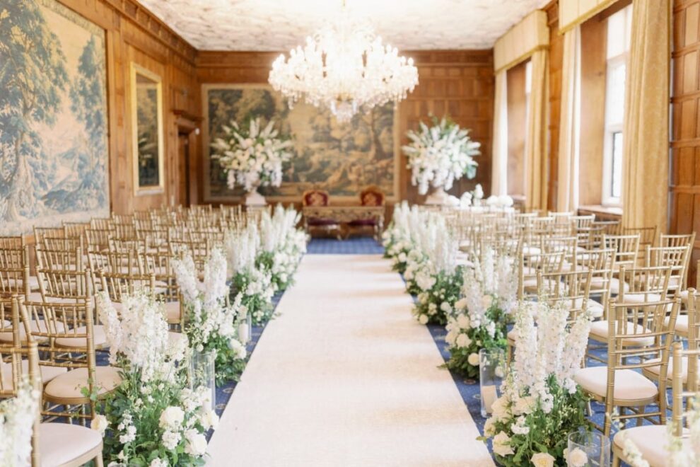 White garden aisle runners and impressive urn designs in the long gallery at North Mymms Park