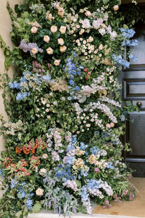 pastel garden floral archway surrounds the door of Hedsor house