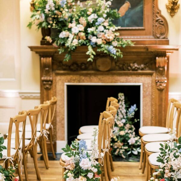 Aisle marker floral designs with a full asymmetrical fireplace floral design