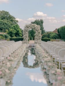 Multi day wedding ceremony floral arch at Four Seasons Hampshire. Florals by Paula Rooney