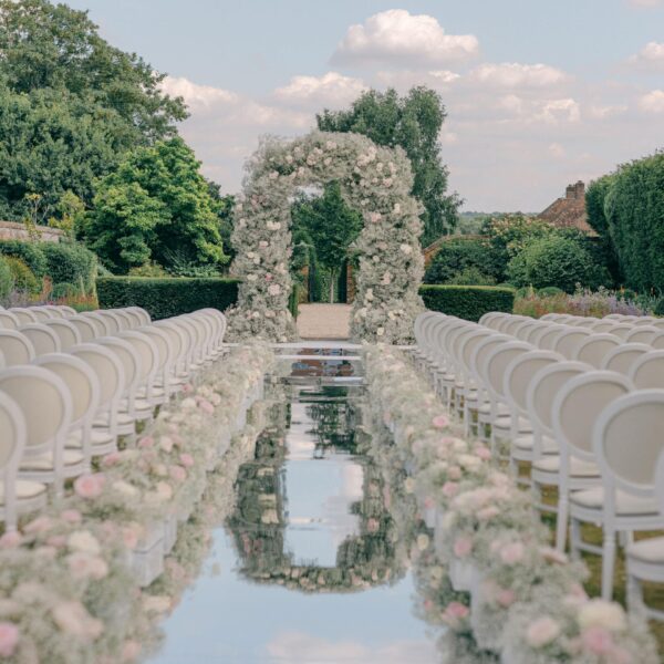 Multi day wedding ceremony floral arch at Four Seasons Hampshire. Florals by Paula Rooney