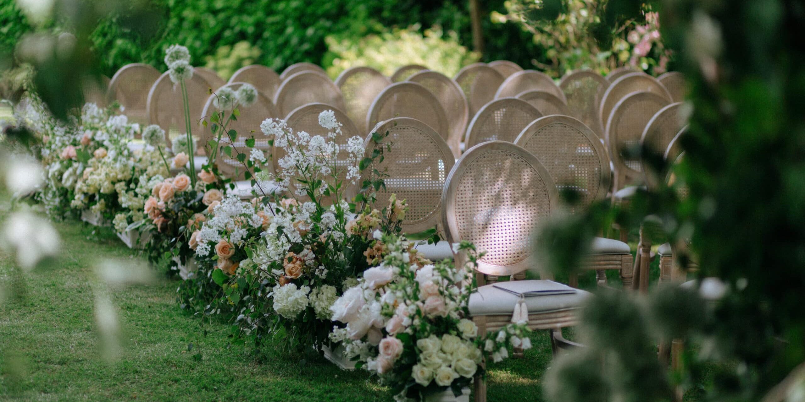 An abundant floral aisle runner filled with groupings of garden0like florals.