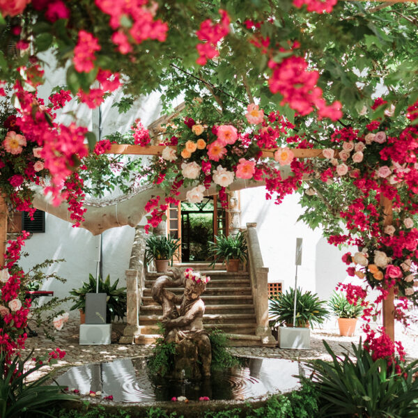 Jardines de Alfabia Wedding Mallorca Violeta Minnick Photography Red Pink Cream Orange Natural Flower Arch Backdrop