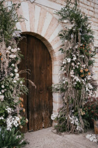 Finca Morneta Wedding Mallorca (c)Liz Greenhalgh Photography Flower Pillars Arch Door Greenery Cream Toffee Wild Natural