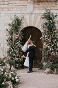 Finca Morneta Wedding Mallorca (c)Liz Greenhalgh Photography Flower Pillars Arch Door Greenery Cream Toffee Wild Natural